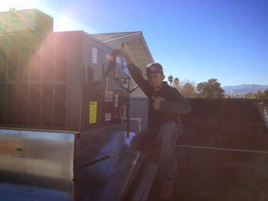 HVAC technician performing Boiler Repair on a rooftop unit in Glendale
